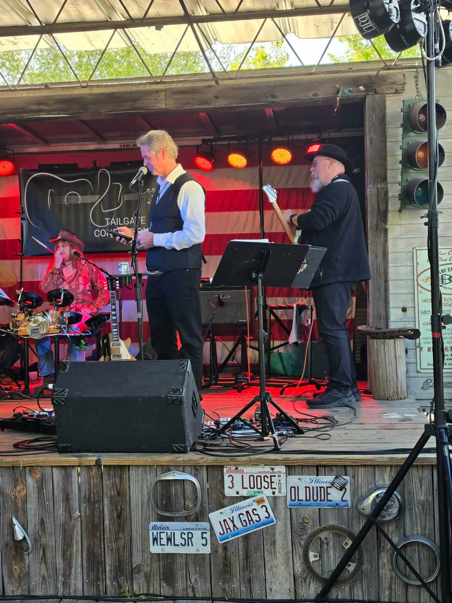 Frontman at the mic with drummer and guitarist